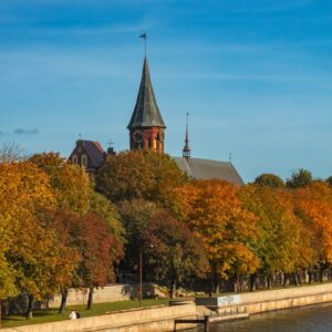 a church on a hill next to a body of water