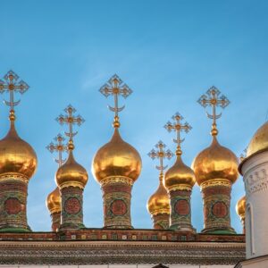 a row of golden domes on top of a building